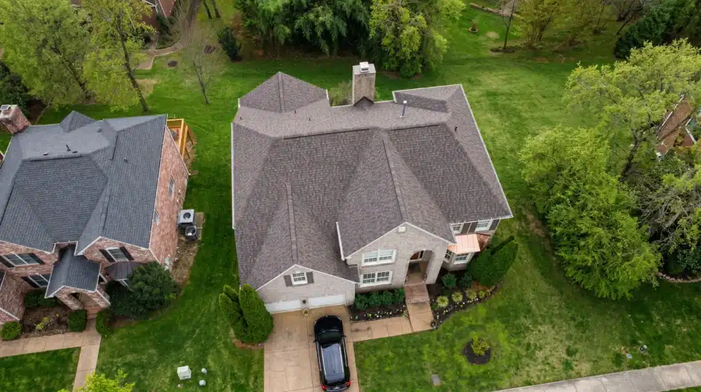 Aerial view of a home with a new roof by Southern Roofing Co., the roofing company Manchester TN homeowners trust