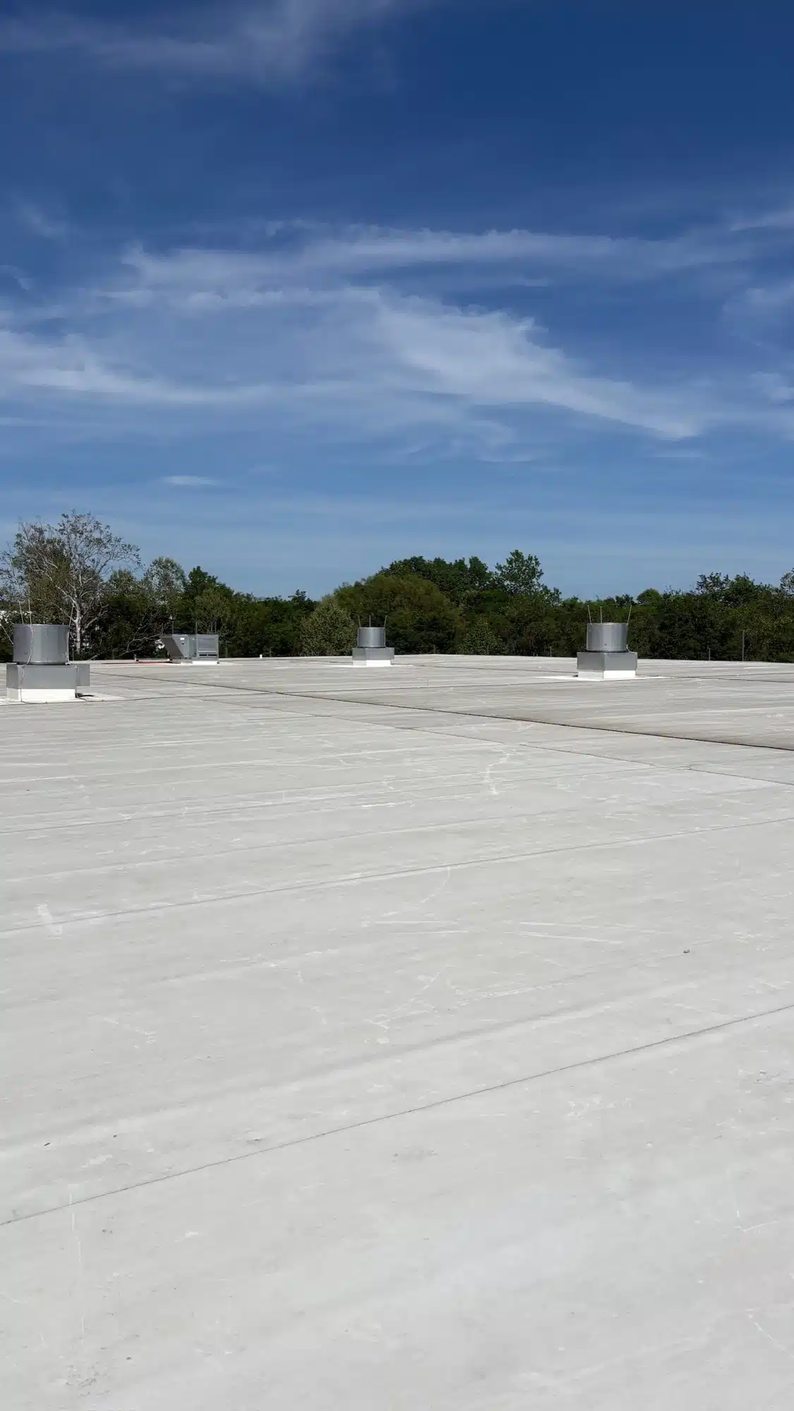 Reflective white membrane on a commercial flat roof — energy-smart commercial building roof design in Middle Tennessee